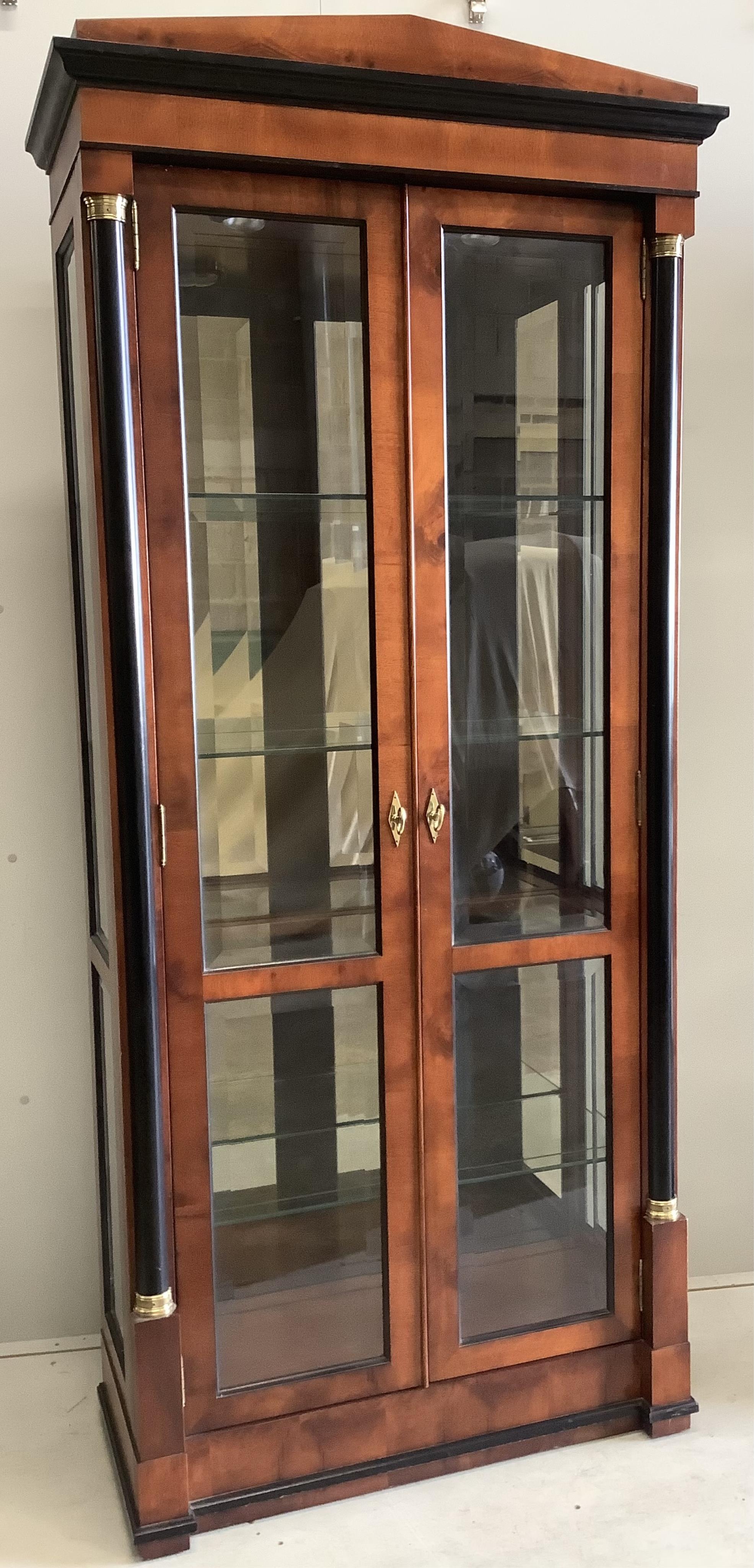 A pair of French Empire style mahogany and ebonised two door display cabinets, width 92cm, depth 42cm, height 210cm. Condition - good